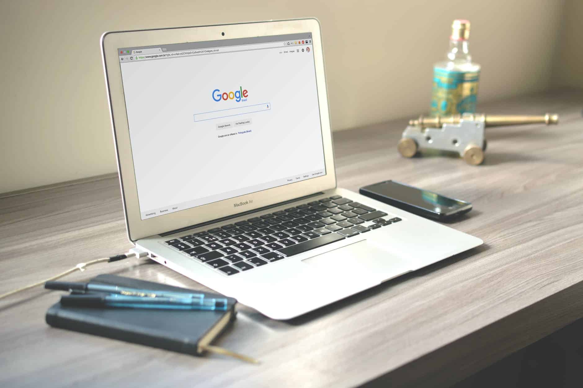 macbook air on grey wooden table. Photo by Caio on Pexels.com