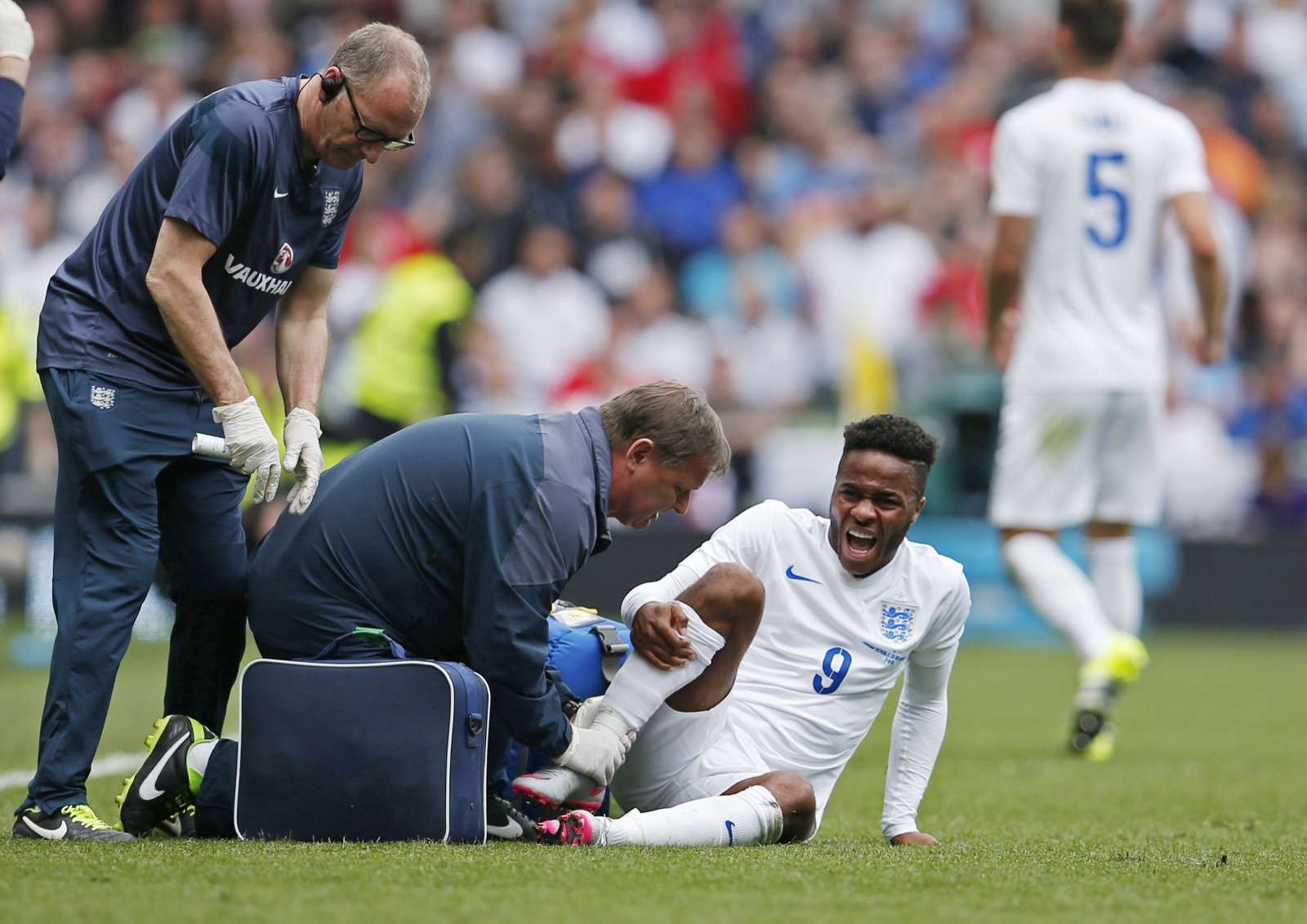 Football medical team treating an injured football player