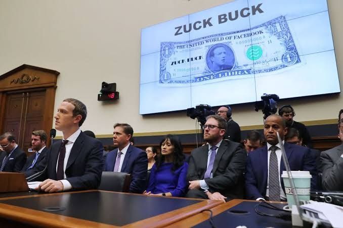Dante Disparte seated directly behind Meta Founder Mark Zukerberg at the 2019 Congressional Hearing on Libra