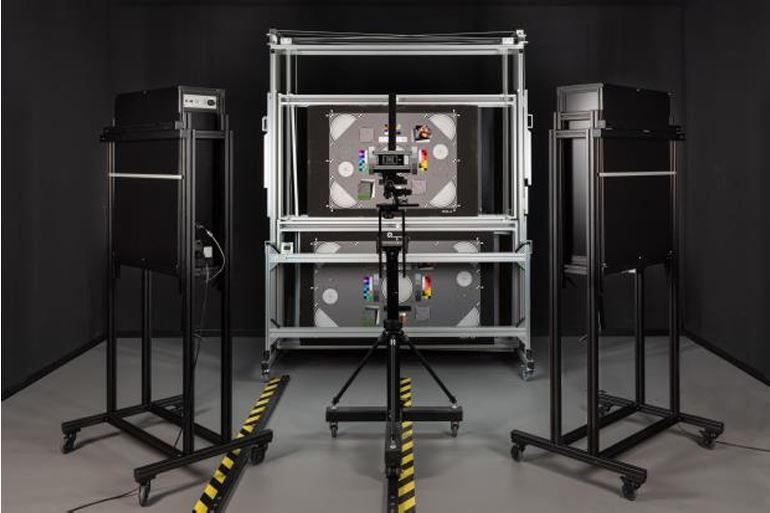 A typical Image Engineering (IE) lab setup, including a central chart stand and uniform light sources on both sides. Source: Image Engineering