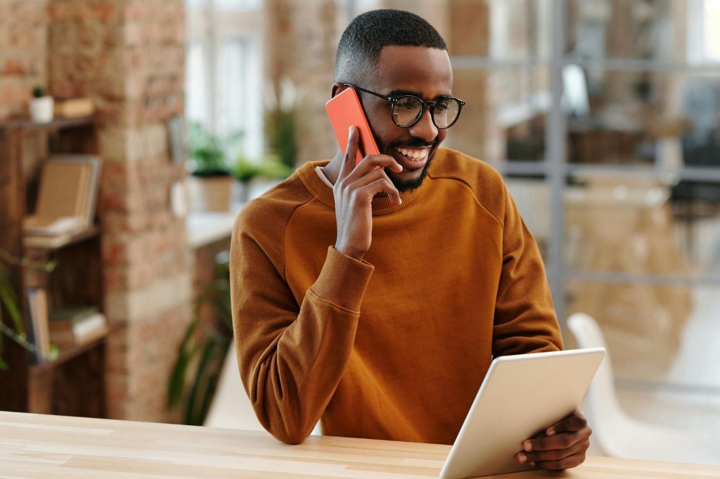 Guy enjoying a phone conversation while working