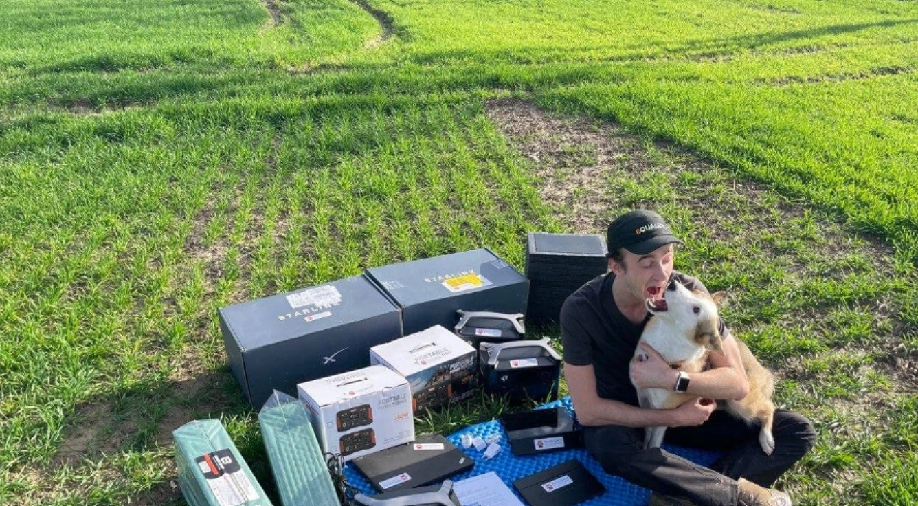 Dmytro Zhluktenko of Dzyga’s Paw posing for a photo with equipment that will be delivered to Ukrainian soldiers on the front. Photo: Dzyga’s Paw