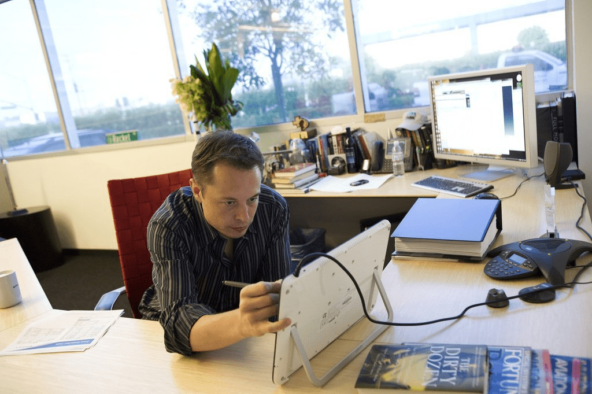 Elon Musk evaluates the drawings of his engineers at SpaceX